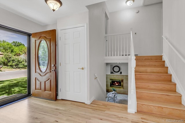 1250 Acropolis Dr, Lafayette, CO 80026 - foyer entrance featuring wood finished floors, stairway, and a fireplace