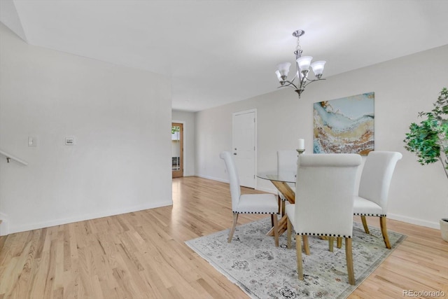 1250 Acropolis Dr, Lafayette, CO 80026 - dining room featuring a chandelier, wood finished floors, and baseboards