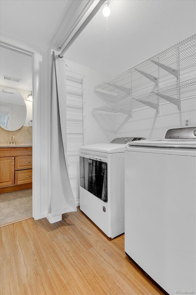 1250 Acropolis Dr, Lafayette, CO 80026 - laundry room with washing machine and clothes dryer and light wood-type flooring