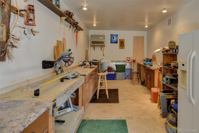 office space featuring a workshop area, recessed lighting, and visible vents