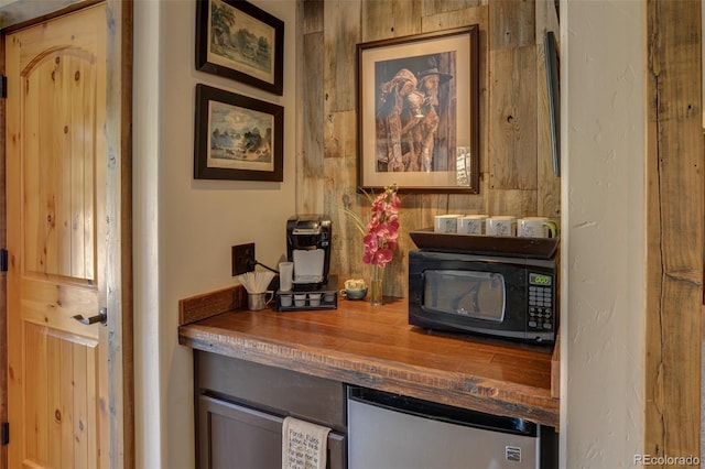 details with refrigerator and black microwave