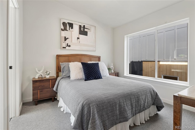 bedroom featuring vaulted ceiling and carpet floors