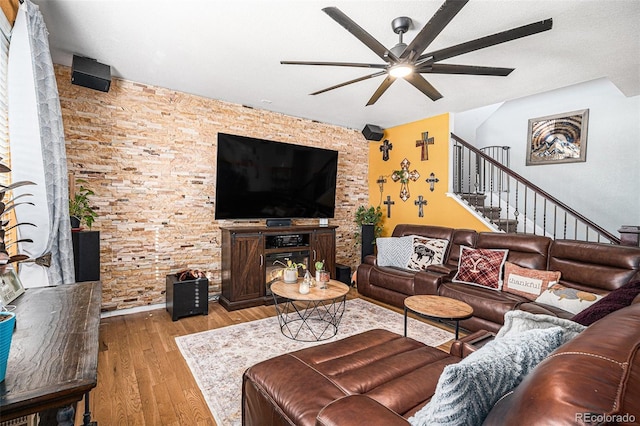 living room with ceiling fan, light hardwood / wood-style flooring, and a textured ceiling