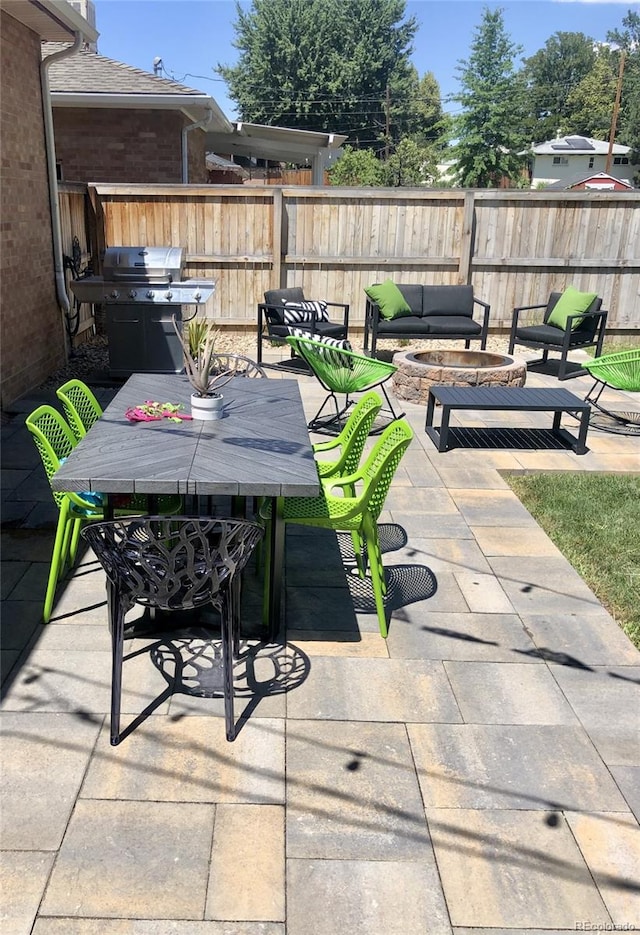 view of patio / terrace with a grill and a fire pit