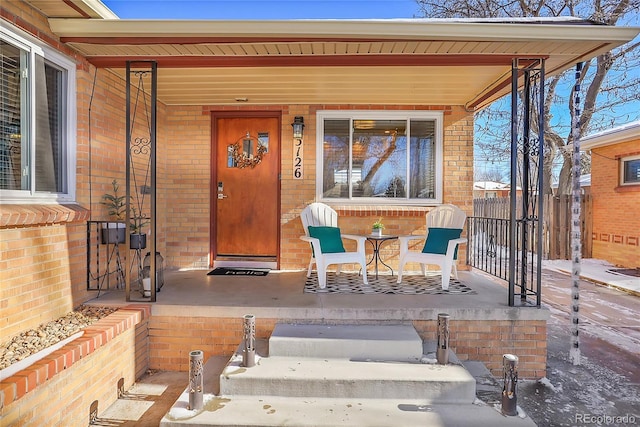 view of exterior entry featuring a porch