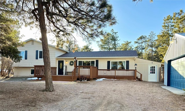 tri-level home featuring a wooden deck