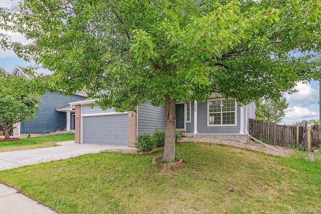 15762 Olmsted Pl, Denver, CO 80239 - view of property hidden behind natural elements with an attached garage, concrete driveway, and brick siding