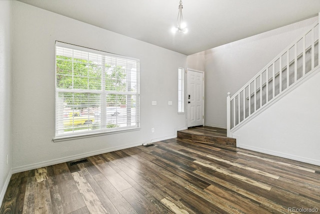 15762 Olmsted Pl, Denver, CO 80239 - entryway with healthy amount of natural light, stairs, dark wood finished floors, and baseboards