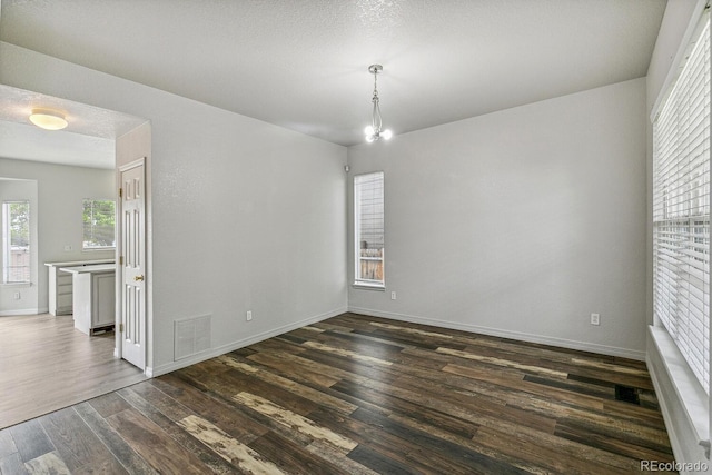 15762 Olmsted Pl, Denver, CO 80239 - spare room with dark wood-style flooring and baseboards