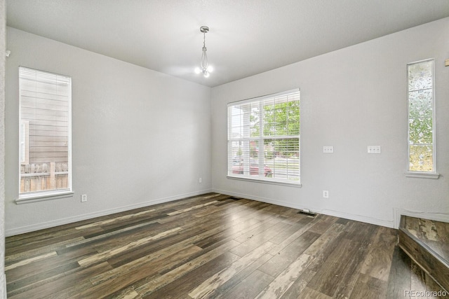 15762 Olmsted Pl, Denver, CO 80239 - spare room featuring dark wood finished floors and baseboards