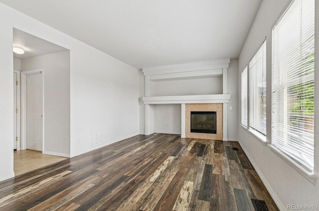 15762 Olmsted Pl, Denver, CO 80239 - unfurnished living room featuring wood finished floors, a fireplace, and baseboards
