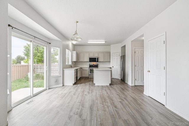 15762 Olmsted Pl, Denver, CO 80239 - kitchen with appliances with stainless steel finishes, light countertops, light wood finished floors, and a sink