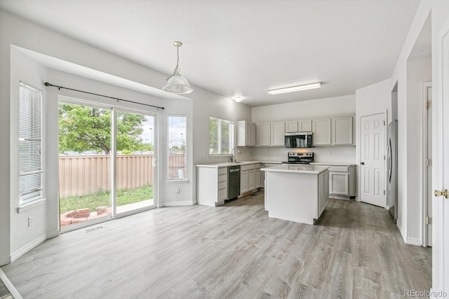 15762 Olmsted Pl, Denver, CO 80239 - kitchen with stainless steel appliances, light countertops, a sink, light wood-style floors, and baseboards