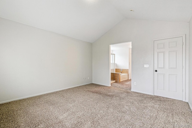 15762 Olmsted Pl, Denver, CO 80239 - unfurnished bedroom with lofted ceiling, carpet floors, baseboards, and ensuite bath
