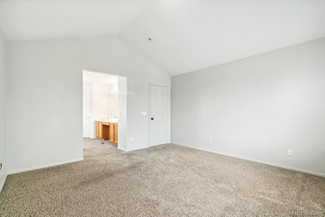 15762 Olmsted Pl, Denver, CO 80239 - unfurnished bedroom with lofted ceiling, light carpet, baseboards, and connected bathroom