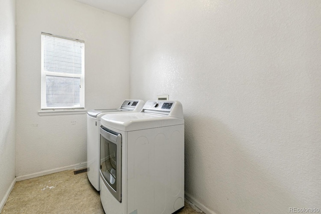 15762 Olmsted Pl, Denver, CO 80239 - washroom with separate washer and dryer, baseboards, and light carpet