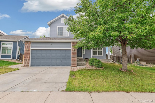 15762 Olmsted Pl, Denver, CO 80239 - view of front of house featuring brick siding, concrete driveway, and an attached garage