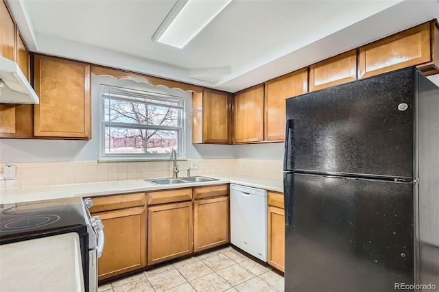 kitchen featuring sink, dishwasher, light tile patterned flooring, stainless steel range with electric cooktop, and black fridge