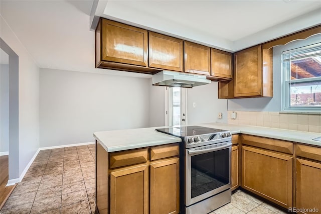 kitchen with stainless steel electric stove and kitchen peninsula