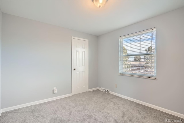 unfurnished room with light colored carpet