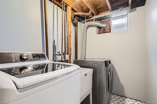 clothes washing area with washer and clothes dryer