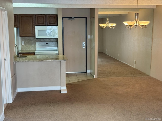 777 N Washington St Unit 1007, Denver, CO 80203 - kitchen featuring white appliances, light colored carpet, a chandelier, tasteful backsplash, and dark brown cabinets