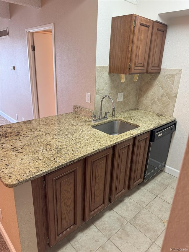 777 N Washington St Unit 1007, Denver, CO 80203 - kitchen featuring dishwasher, backsplash, light stone countertops, a peninsula, and light tile patterned floors