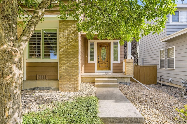 9975 Blackbird Cir, Highlands Ranch, CO 80130 - doorway to property featuring brick siding