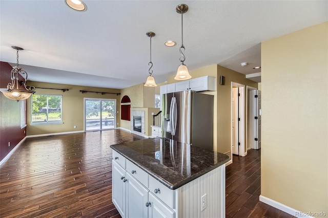 9975 Blackbird Cir, Highlands Ranch, CO 80130 - kitchen featuring stainless steel refrigerator with ice dispenser, dark wood finished floors, open floor plan, white cabinets, and recessed lighting
