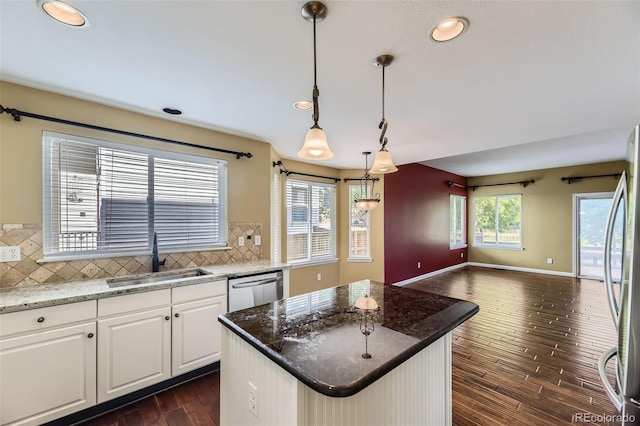 9975 Blackbird Cir, Highlands Ranch, CO 80130 - kitchen with open floor plan, dark wood-style flooring, backsplash, a center island, and stainless steel appliances