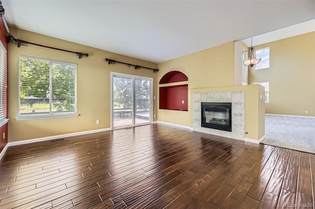 9975 Blackbird Cir, Highlands Ranch, CO 80130 - unfurnished living room featuring wood finished floors and a tiled fireplace