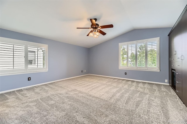 9975 Blackbird Cir, Highlands Ranch, CO 80130 - unfurnished bedroom featuring lofted ceiling, multiple windows, light carpet, and a ceiling fan