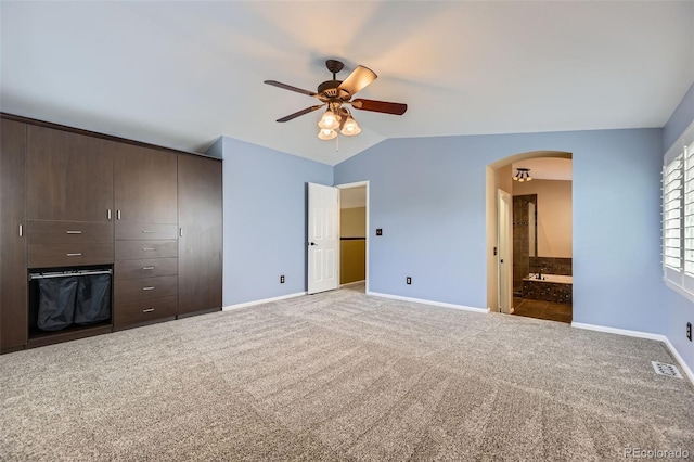 9975 Blackbird Cir, Highlands Ranch, CO 80130 - unfurnished bedroom with arched walkways, vaulted ceiling, carpet, a closet, and ensuite bathroom