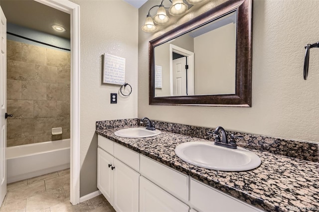 9975 Blackbird Cir, Highlands Ranch, CO 80130 - bathroom with double vanity, a textured wall, and shower / bath combination