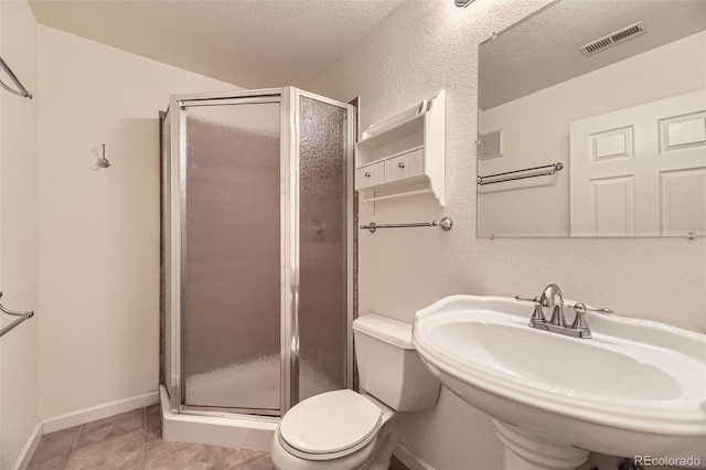 9975 Blackbird Cir, Highlands Ranch, CO 80130 - bathroom featuring a stall shower and a textured ceiling