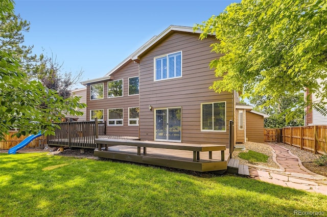9975 Blackbird Cir, Highlands Ranch, CO 80130 - rear view of house with a fenced backyard, a wooden deck, and a playground