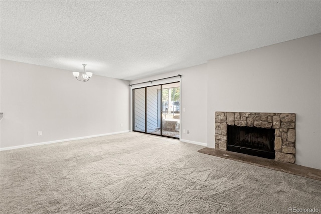 unfurnished living room featuring a stone fireplace, a textured ceiling, and carpet floors