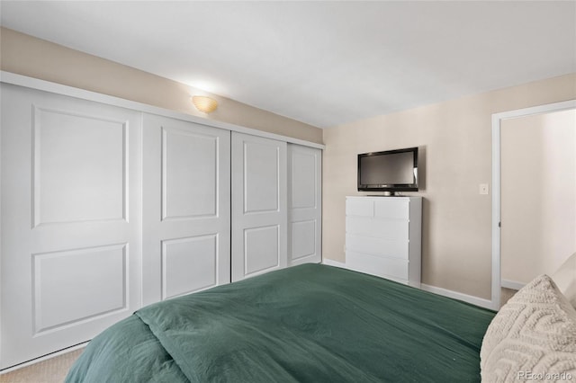 carpeted bedroom featuring a closet