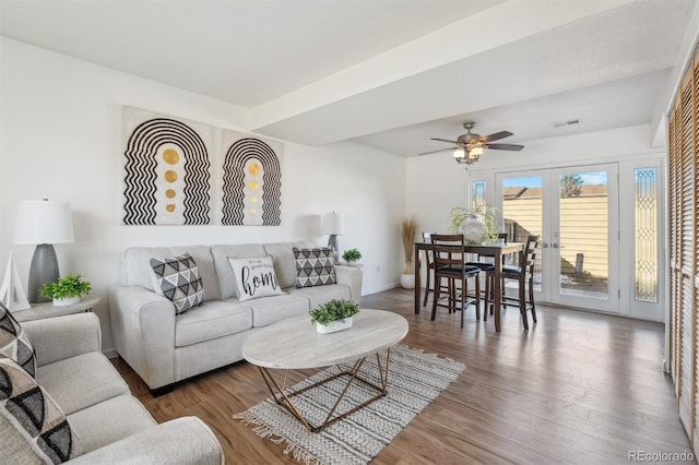 living room featuring visible vents, baseboards, a ceiling fan, wood finished floors, and french doors