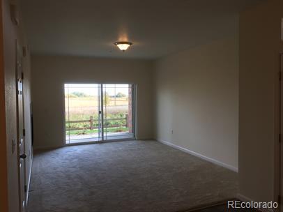 804 Summer Hawk Dr Unit 6105, Longmont, CO 80504 - carpeted empty room featuring baseboards