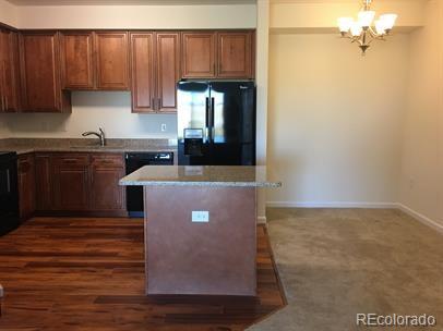 804 Summer Hawk Dr Unit 6105, Longmont, CO 80504 - kitchen with refrigerator with ice dispenser, dishwasher, a chandelier, a center island, and pendant lighting