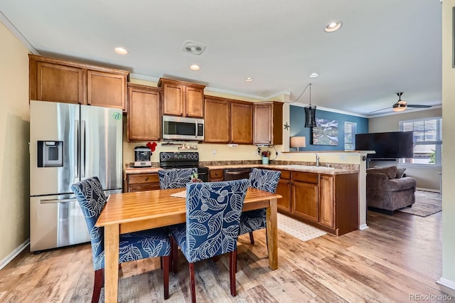 24748 E Layton Pl, Aurora, CO 80016 - kitchen featuring appliances with stainless steel finishes, a peninsula, brown cabinetry, light wood-style floors, and recessed lighting