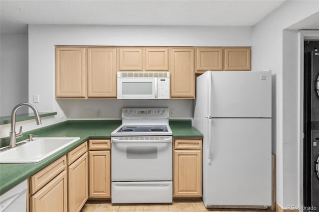 kitchen with white appliances, light brown cabinets, a sink, and light tile patterned floors