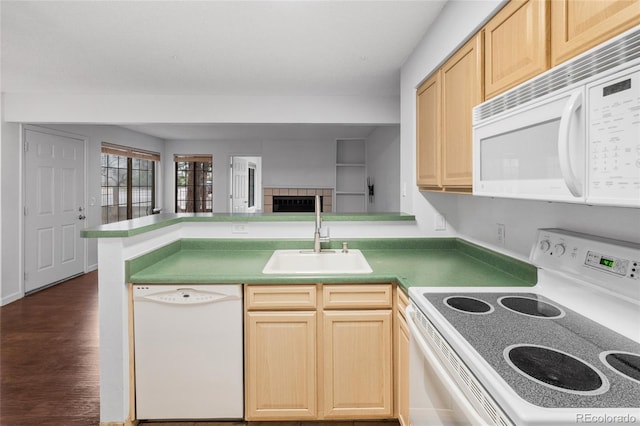 kitchen with white appliances, light brown cabinets, a sink, and dark wood-style flooring