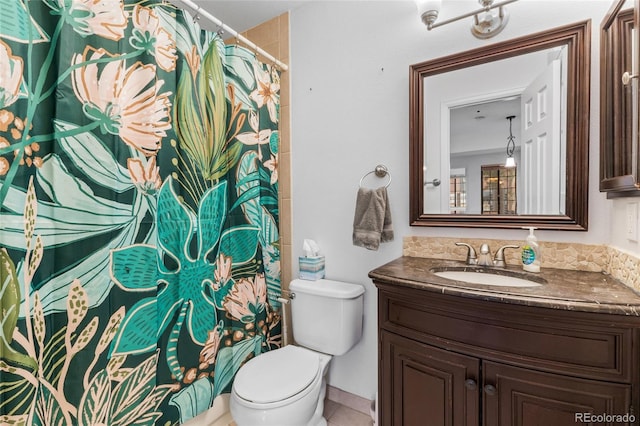 bathroom with toilet, tile patterned floors, and vanity