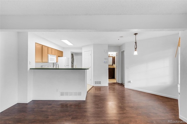 unfurnished living room featuring baseboards, a textured ceiling, visible vents, and dark wood-style flooring