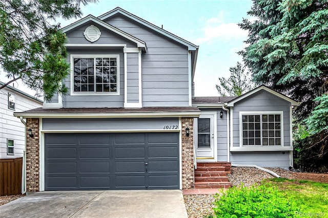 10172 Woodrose Ln, Highlands Ranch, CO 80129 - view of front of house featuring concrete driveway, a garage, brick siding, and a shingled roof