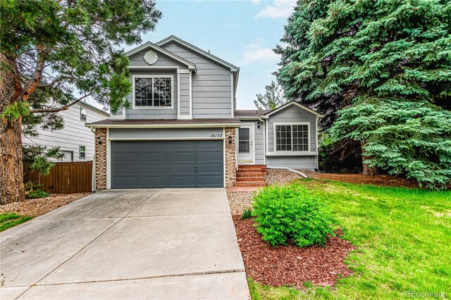 10172 Woodrose Ln, Highlands Ranch, CO 80129 - view of front of house with an attached garage, concrete driveway, and brick siding