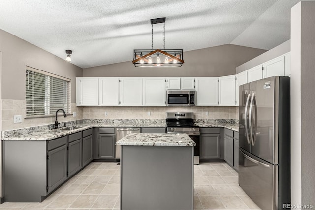 10172 Woodrose Ln, Highlands Ranch, CO 80129 - kitchen with stainless steel appliances, lofted ceiling, light stone countertops, gray cabinets, and a center island