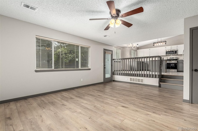 10172 Woodrose Ln, Highlands Ranch, CO 80129 - unfurnished living room with a chandelier, a textured ceiling, light wood finished floors, a ceiling fan, and vaulted ceiling